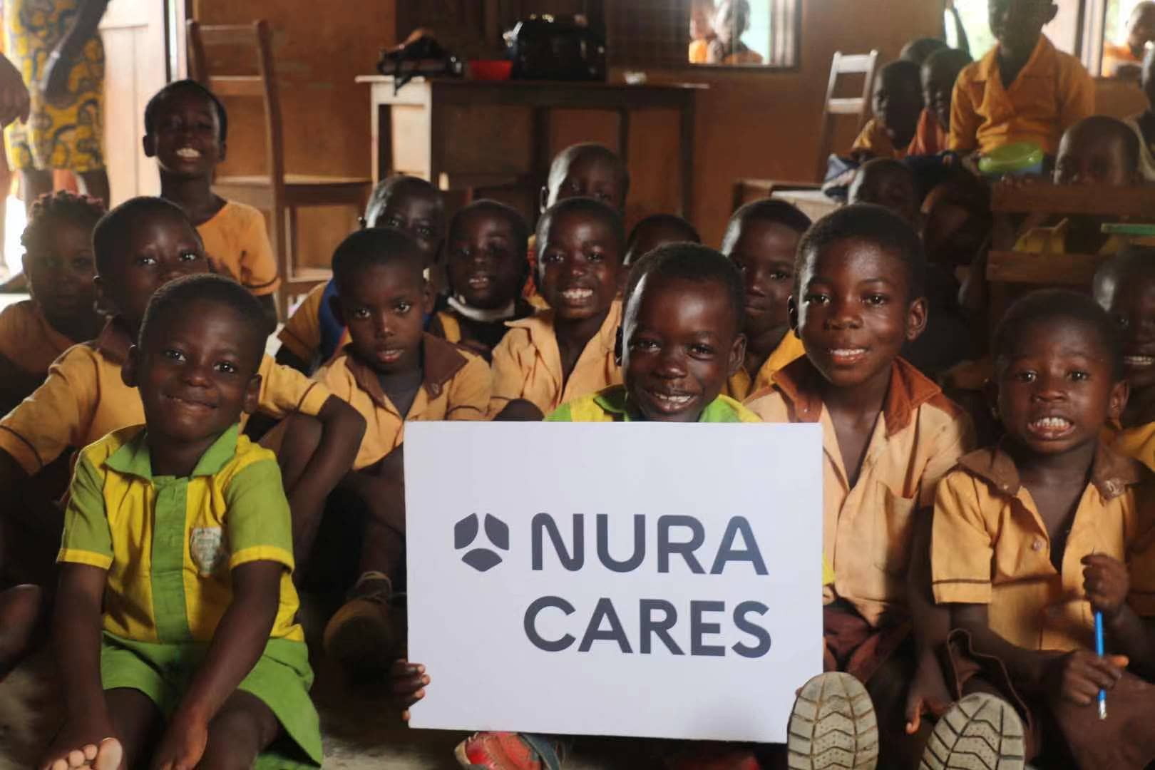 children holding sign that reads nura cares